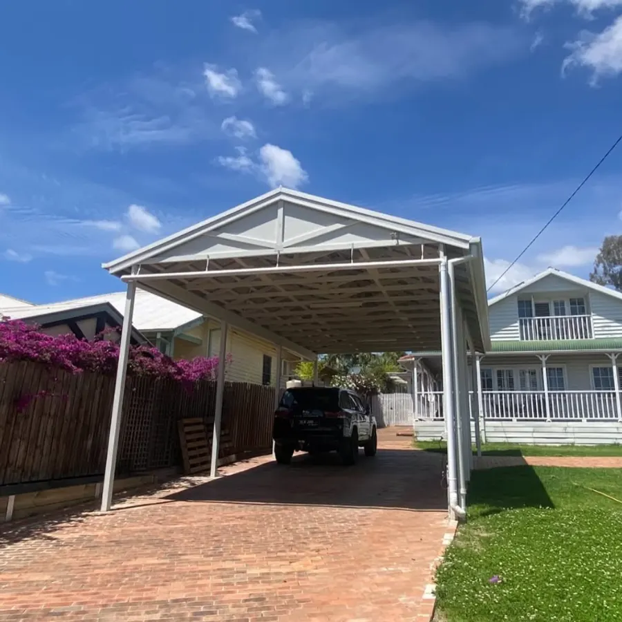 Completed gable carport with a vehicle parked underneath