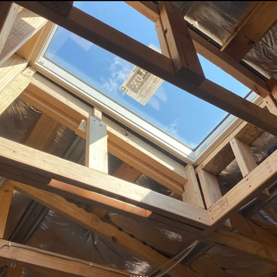 Skylight framed into the roof structure with clear sky above