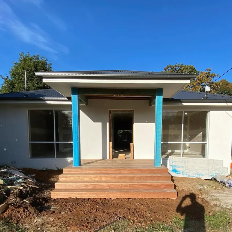 Structural steel posts framing a new entry and portico