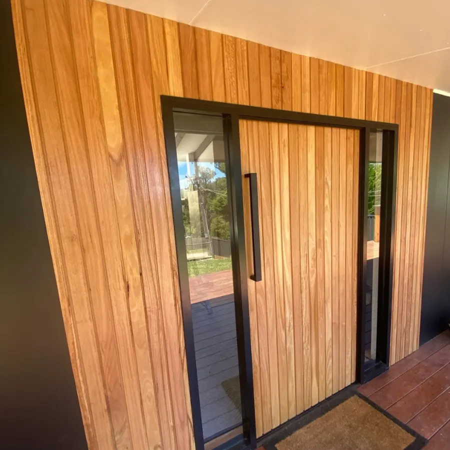 Vertical timber cladding wrapping a custom entry