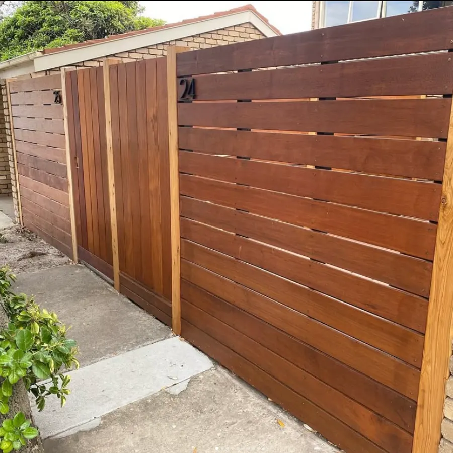 Horizontal timber slat fence with a matching pedestrian gate