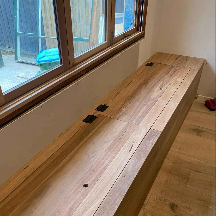 Custom timber window seat with hinged storage lids